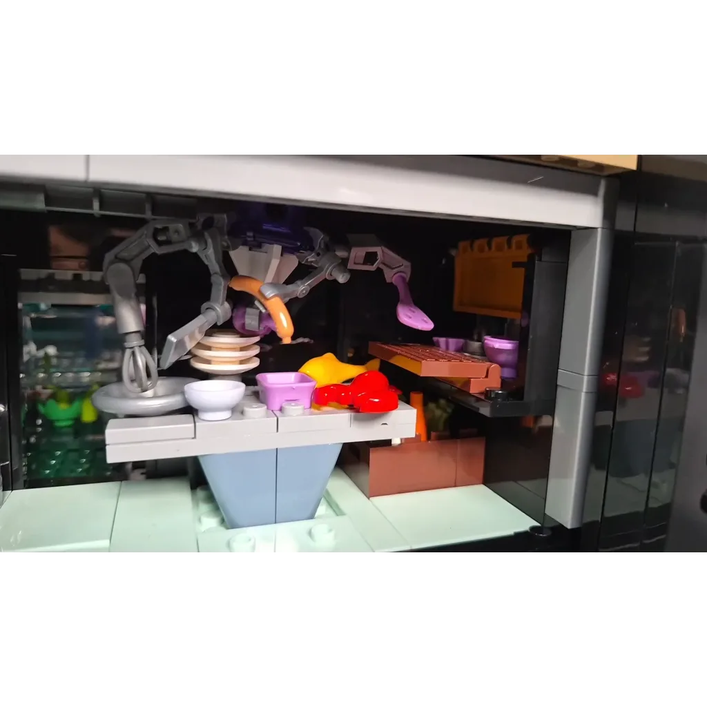 Cuisine du Neon Elite Lounge ouverte, avec les bras robotisés, les paniers de légumes et le homard